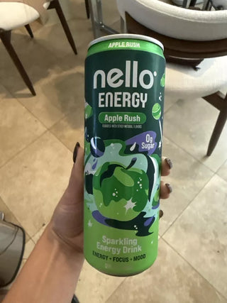 Nello Energy can in a hand against a kitchen floor