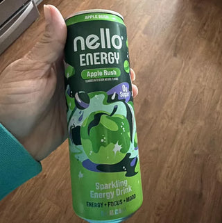 Nello Energy can in a hand against a wooden floor