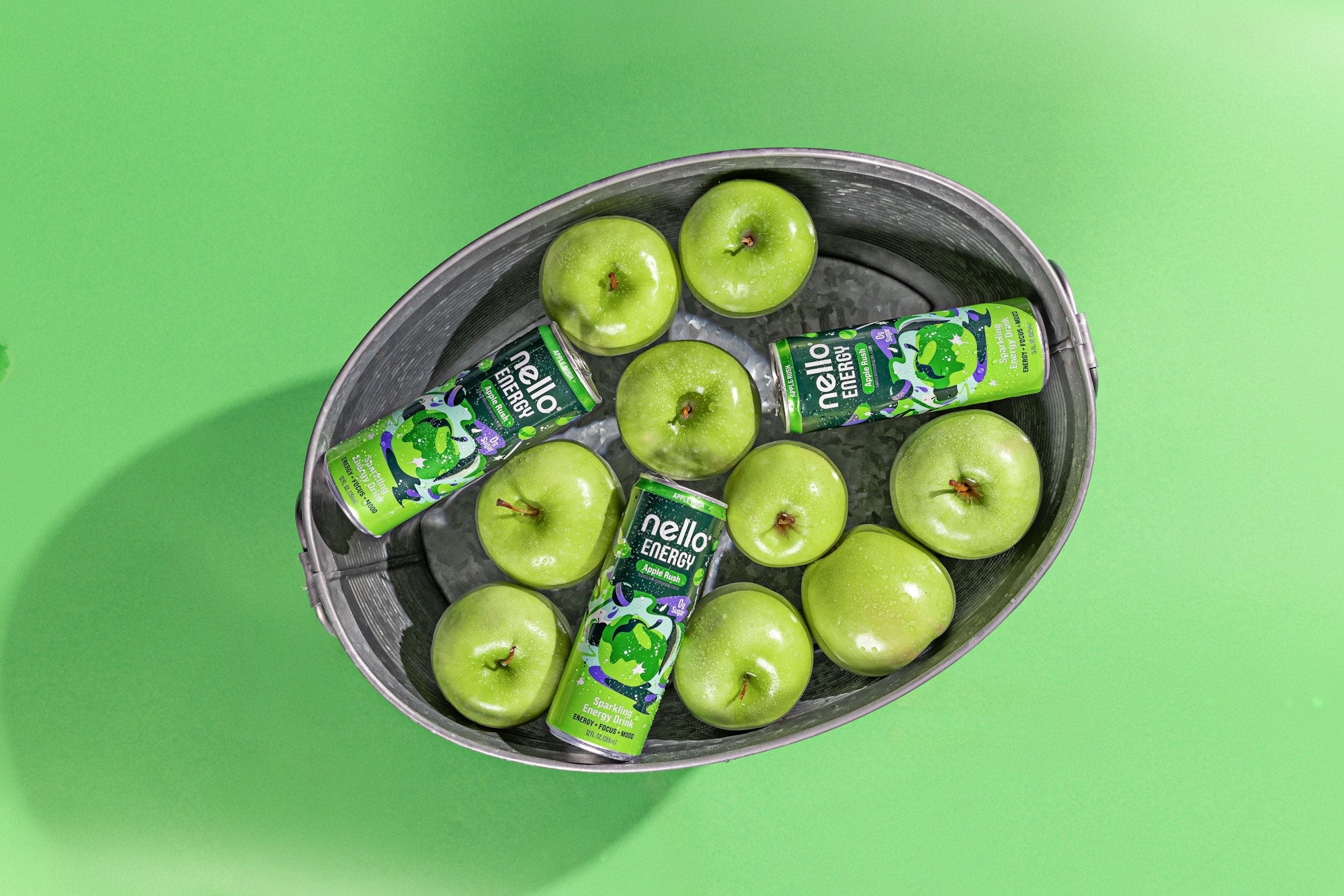 Nello Energy cans with green apples in basket