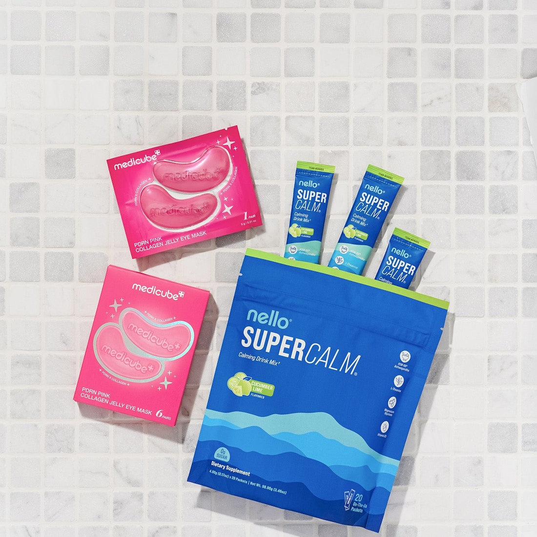 Nello Supercalm with medicube jelly eye masks laid out on white tile